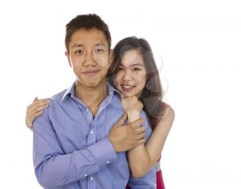 horizontal photo of a young adult couple holding each other while smiling isolated on white