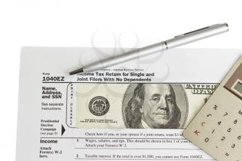 Tax form with paper money, silver pen, calculator on white background