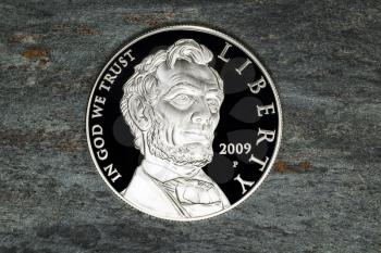 Fine Lincoln Silver Dollar on Natural Stone Background