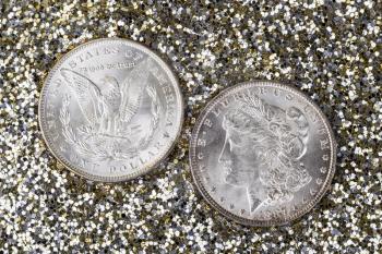 Obverse and Reverse of American Silver Dollar on Gold and Silver Glitter Background