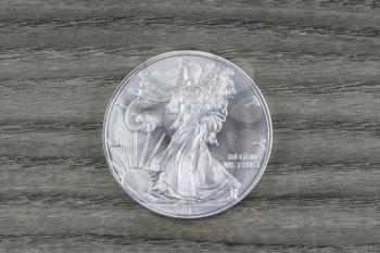 Brand new United States Silver Dollar - Walking Liberty- on Vintage White Oak wood serving as background