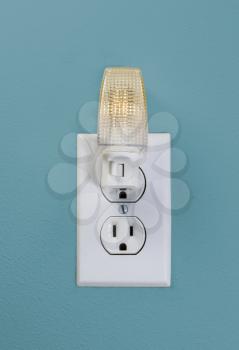 Small White LED Wall Light plugged into electrical wall outlet