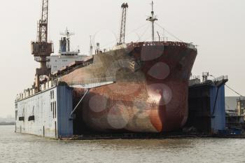 Old Cargo ship docked for hull maintenance in Chinese Harbor