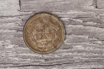 Copper One Cent coin on Synthetic Wood