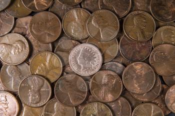 one cent pieces with rare Indian Head Cent in middle of pile
