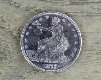 United State Silver Trade Dollar on Faded White Ash Wood