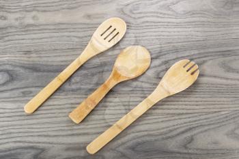 Wooden spoon set on fading white ash wood background