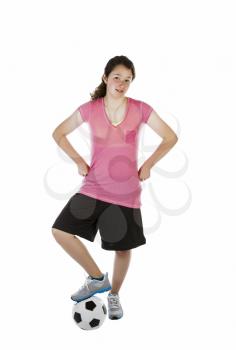 Vertical photo of young girl with soccer ball under rigth foot on white background  