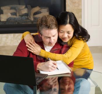 Photo of close mature couple displaying happiness while working from home with fireplace in background  