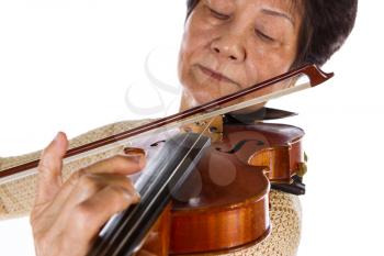 Closeup horizontal photo of violin string and bow touching with senior woman in background 