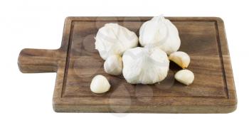 Horizontal photo of fresh raw garlic on black walnut board isolated on white