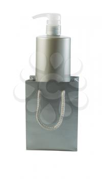 Vertical photo of plastic bottle inside of silver shopping bag isolated on white background