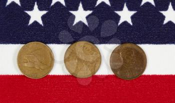 Closeup view of United States One Cent Pieces, original start dates, placed on American Flag 
