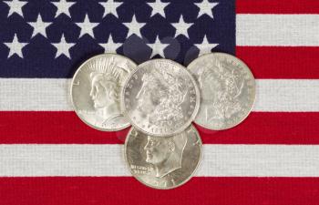 Closeup view of United States Silver Dollar Coins placed on American Flag 