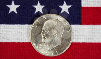Closeup view of United States Silver Dollar Coins, President Eisenhower, placed on American Flag 