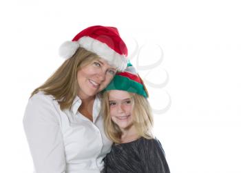 Front view, shoulders up, of mother and her young daughter wearing Christmas hats isolated on a white background 