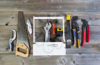Over head view of basic home repair tools and holder on rustic wooden boards