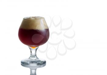 Horizontal image of fresh dark beer in glass goblet on white with reflection