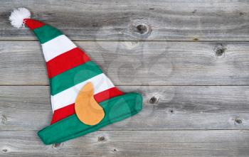 Horizontal image of Christmas elf stocking hat on rustic wooden boards