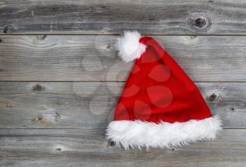 Horizontal image of Christmas Santa hat on rustic wooden boards