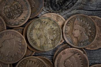 Extreme close up view of One Cent vintage coins on rustic wood