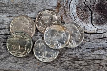 Rare buffalo head nickel coins on rustic wood