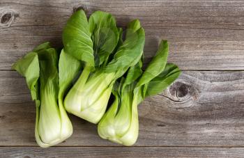 Overhead shot of Chinese cabbage, Bok Choy, on rustic wood