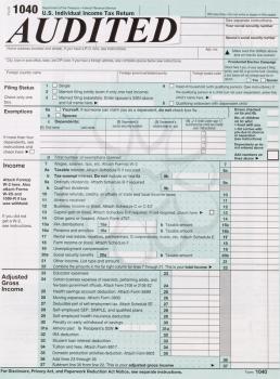Vertical image of individual income tax form with the word, in large letters, audit. Business financial concept for tax purposes. 