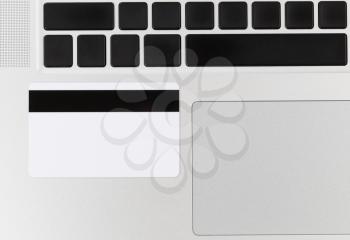 Close up of credit card on computer. Concept of fraud or phishing scheme with technology. 