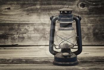 Vintage concept of a old lantern on rustic wood