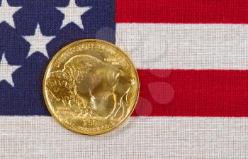 United States Mint issued American Buffalo coin, fine gold, on USA flag. 