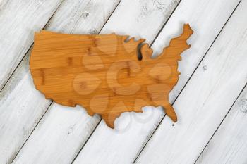 Wooden shape of United of America with rustic white wood underneath. 
