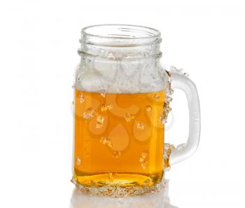 Ice cold amber beer in jar glass. Isolated on white background with reflection. 