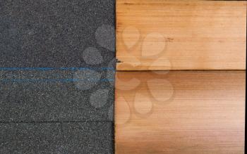 Side by side comparison of high quality new composite and cedar shake shingles in horizontal format. 
