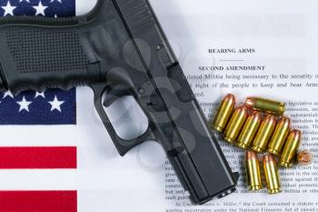 Pistol, bullets, USA flag and Text of second amendment for the right to bear arms. 