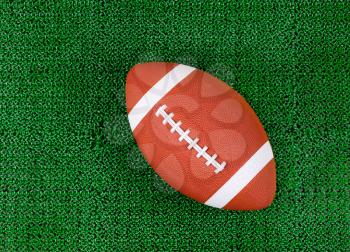 Overhead view of American football on artificial grass 