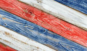 Angled faded wooden boards painted red, white and blue for patriotic concept of United States of America. 