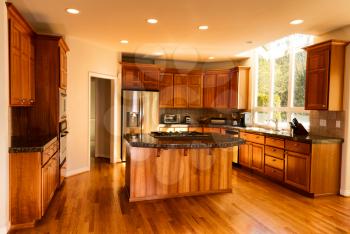Open view of large home kitchen with all stainless steel appliances 