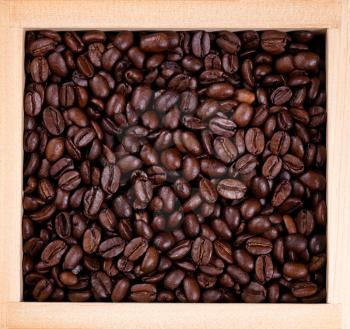 Top view of freshly roasted coffee beans in wooden box. 