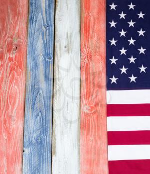 USA flag border on vertical rustic painted wooden boards in national colors of country. 