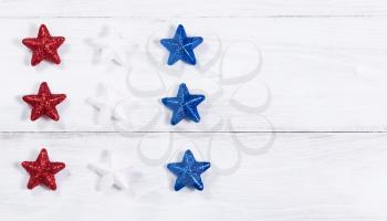 Stars in USA national colors on rustic white wooden boards. Fourth of July holiday concept for United States of America.  