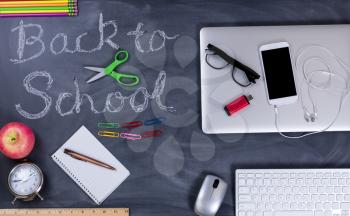 Back to school concept with traditional supplies on left side and modern technologies on right side of image. 
