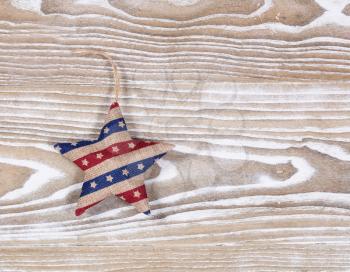 Stuffed star object in USA national colors on rustic white wooden boards. Fourth of July holiday concept for United States of America.  