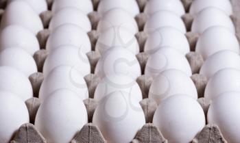 Full carton of fresh whole eggs with select focus on front of image. 