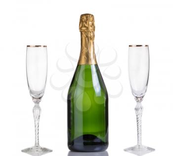 Champagne bottle with drinking glasses isolated on white with reflection