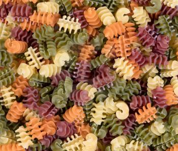 Fill frame layout of colorful raw twisted pasta background