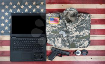 United States military equipment with modern technology on rustic wooden flag
