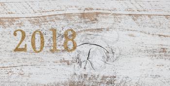 2018 gold numbers on rustic white wood