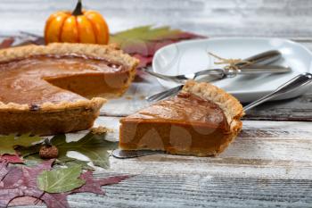 A slice of fresh homemade pumpkin pie for Thanksgiving ready to eat