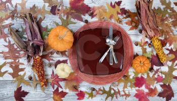 Traditional Thanksgiving holiday dinner table setting on rustic table with autumn decorations
